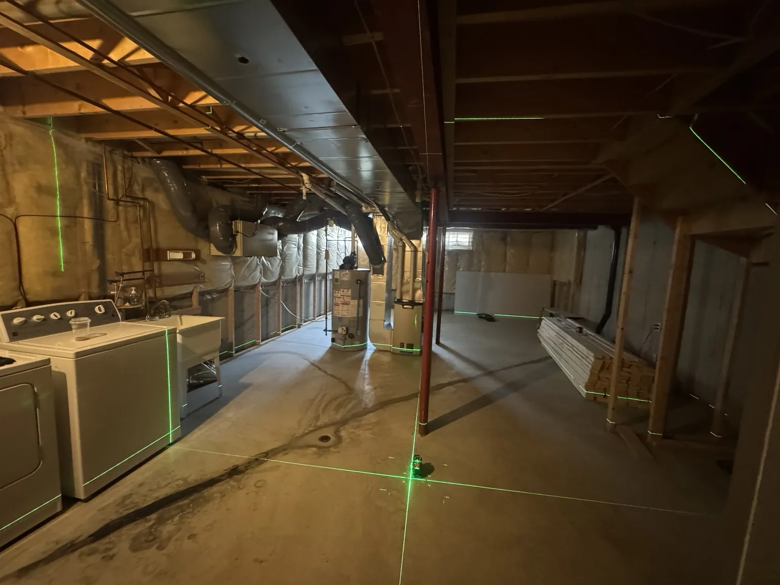 Unfinished basement undergoing renovation with exposed joists