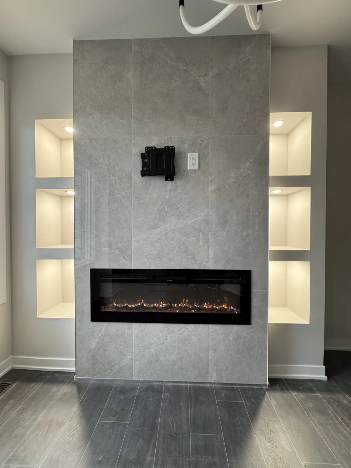 Completed gray tiled fireplace feature wall