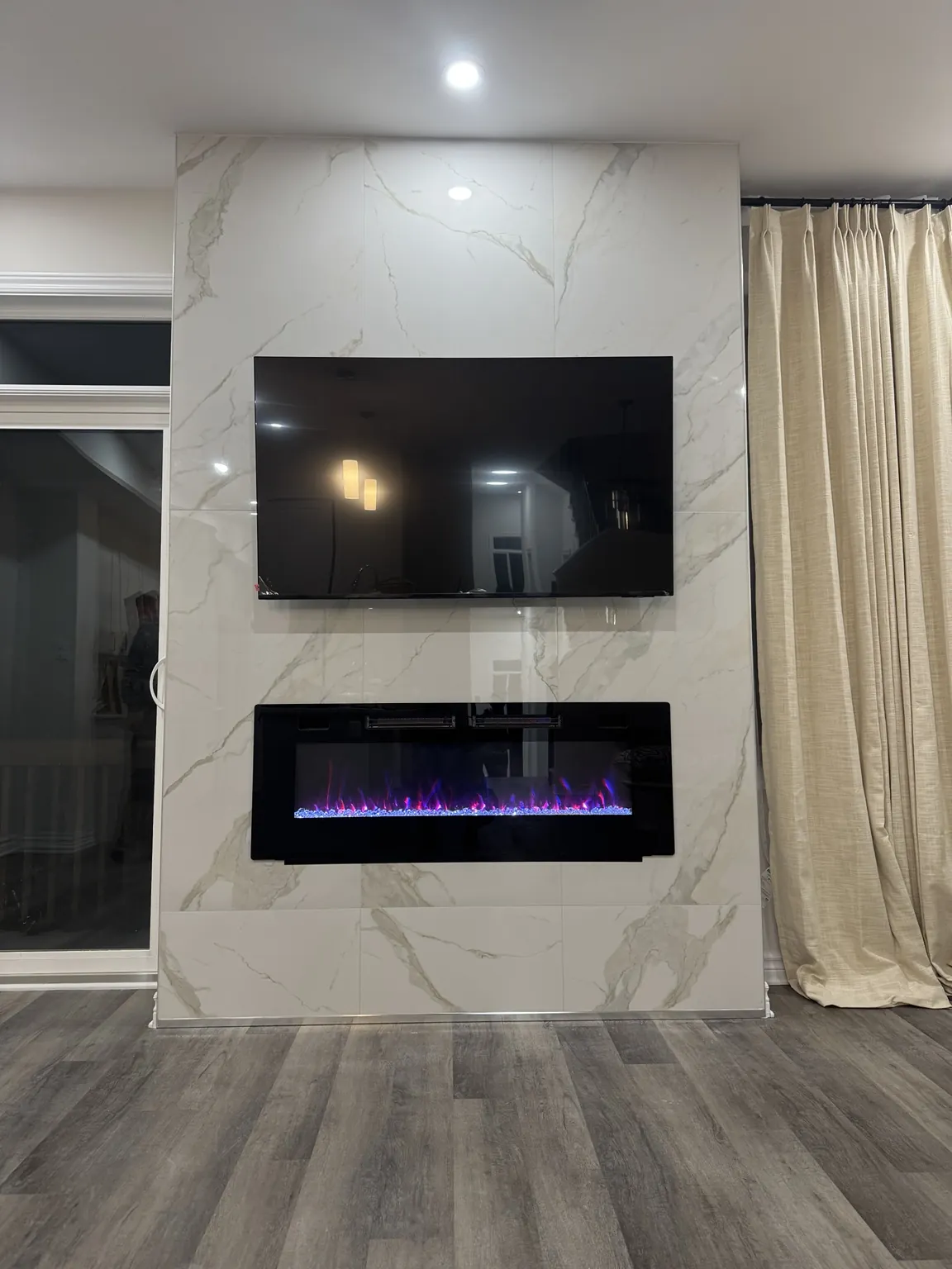 Finished white tile fireplace surround and television