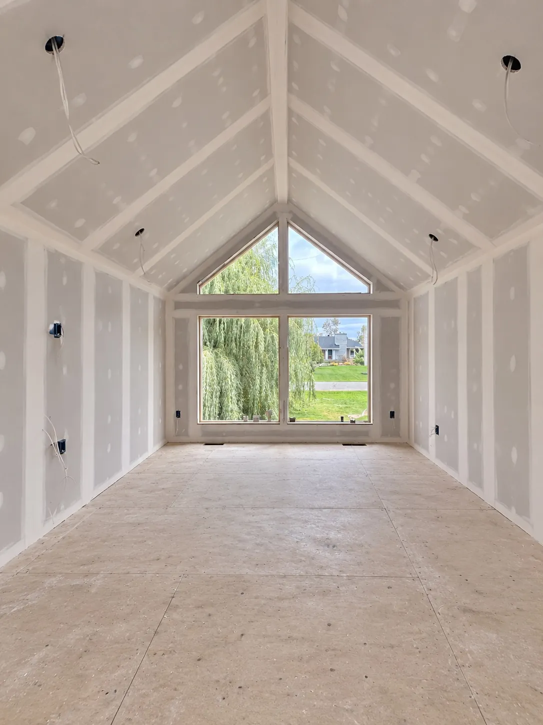 Same vaulted ceiling area with drywall installed and seams taped