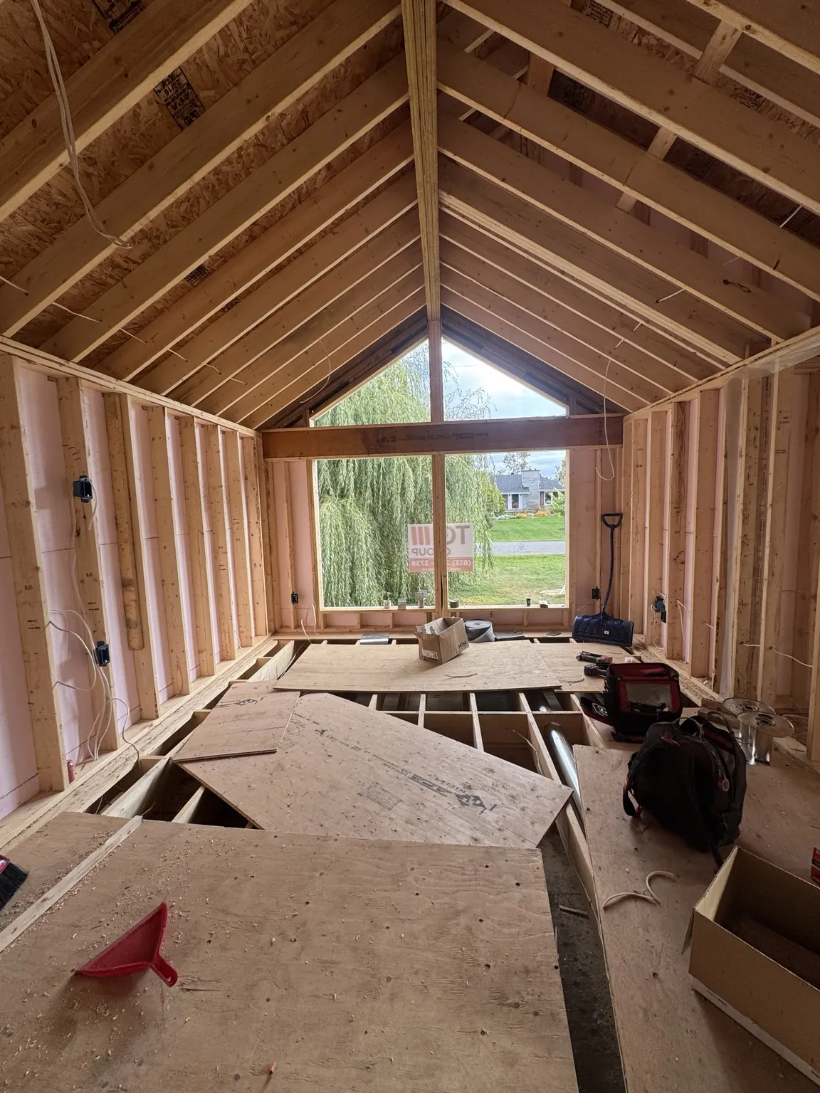 Exposed wood framing in vaulted ceiling room